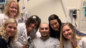 Nurse Sloane and her colleagues posing with a patient