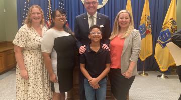 Advocates standing alongside NJ governor for the medical debt bill signing ceremony