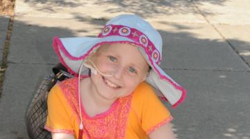 Maddy smiling, wearing a floppy hat