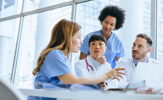 Healthcare professionals speaking to eachother at a table