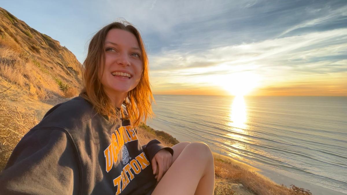 Mollie sitting next to a body of water